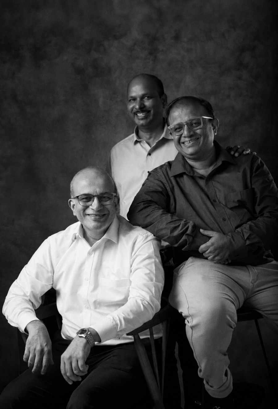 Three senior team members in a black and white portrait